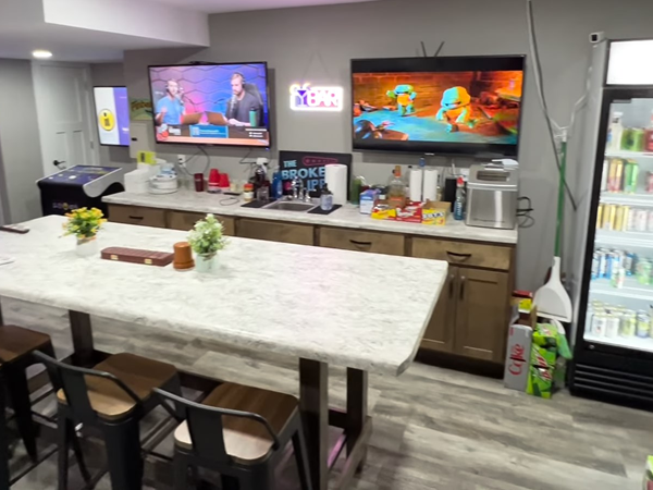 View of the Bar area and popcorn maker. Two screens and refrigerator.
