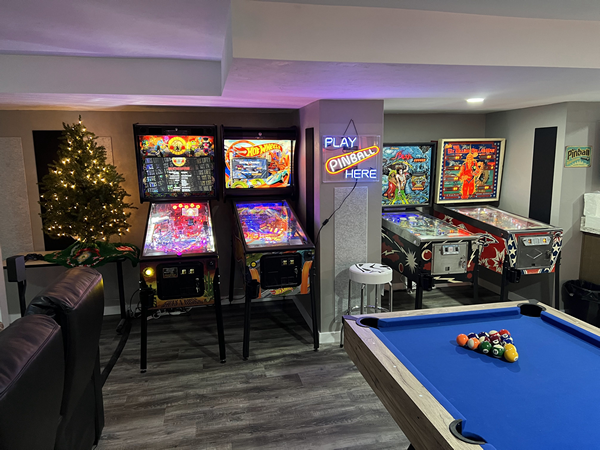 A view of our other pinball wall showing Jersey Jack games, American Pinball, and some classics from the 1970s and the pool table.